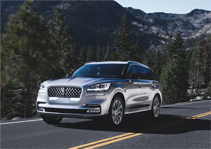 A 2023 Lincoln Aviator® Grand Touring SUV being driven on a winding road to demonstrate the capabilities of all-wheel drive | Koons Lincoln of Bethesda in Silver Spring MD